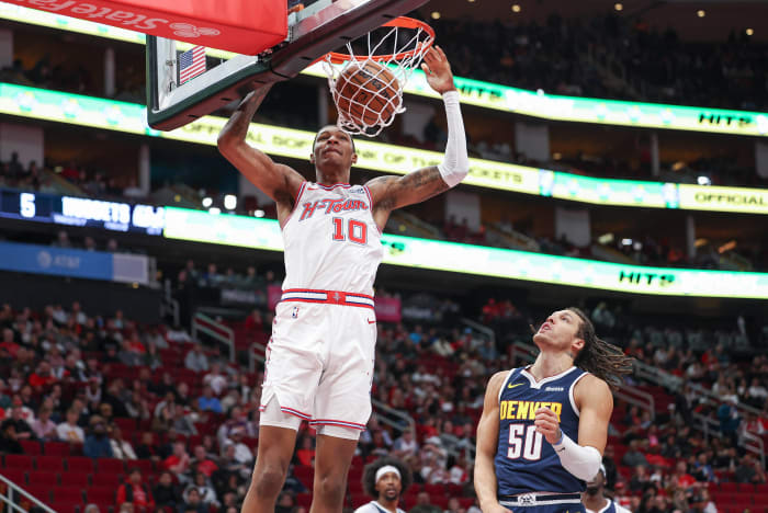 Rockets forward Jabari Smith Jr. dunks the ball as Denver Nuggets forward Aaron Gordon (50) defends during the first quarter at Toyota Center.